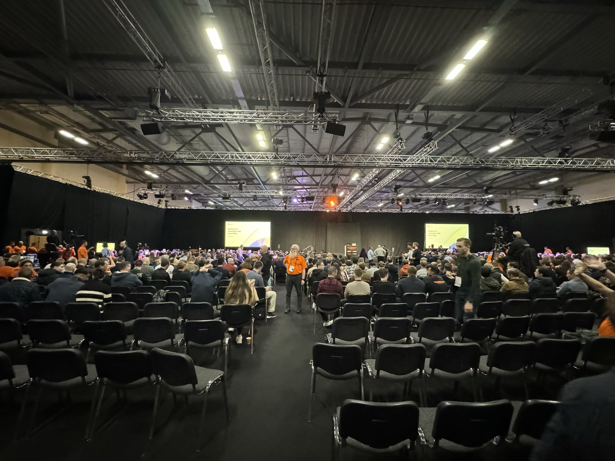 a picture from the back of the keynote session, there many hundreds of people sat down waiting to hear Microsoft's keynote, many helpers are still ushering in attendees